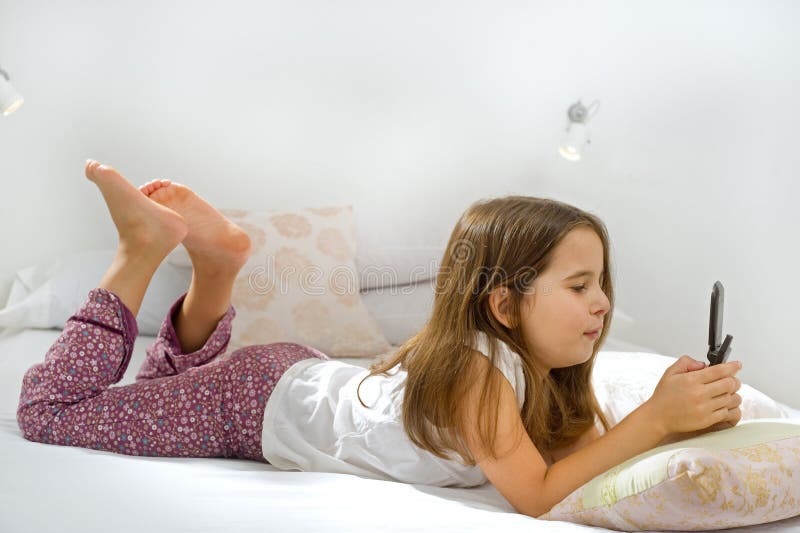 Girl lying on bed with cell phone