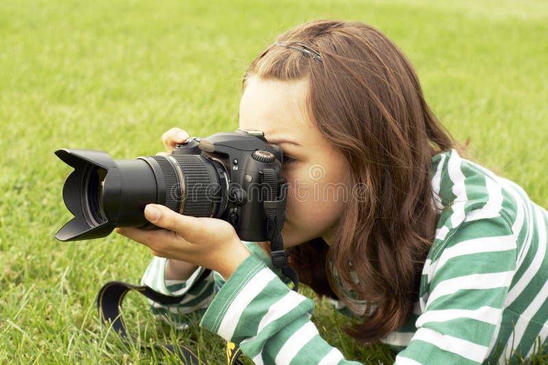 Girl lying with photo camera