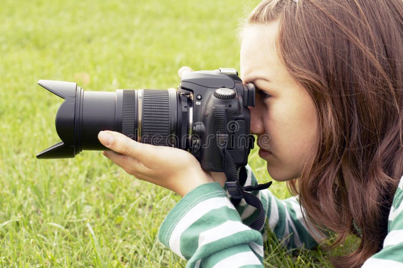 Girl lying with photo camera