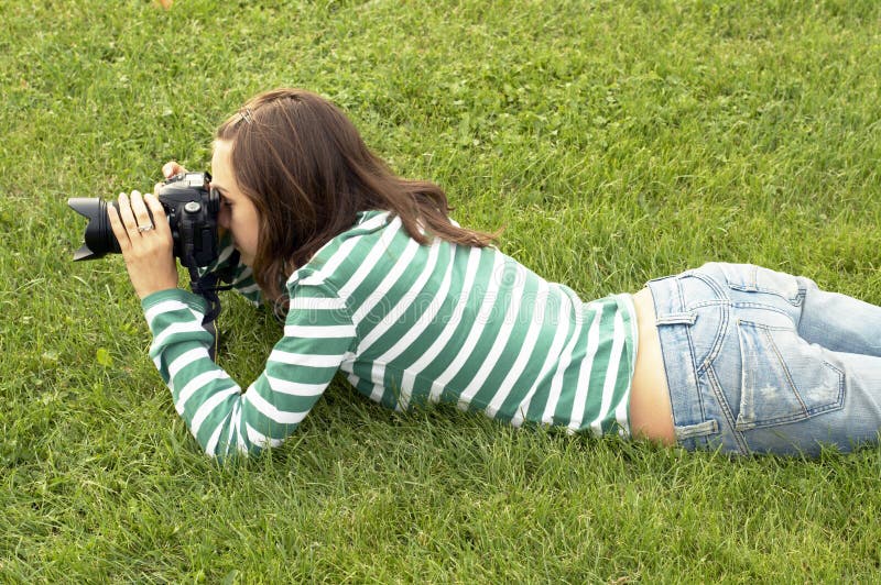 Girl lying with photo camera