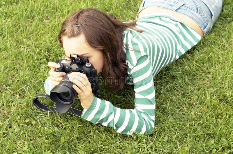 Girl lying with photo camera