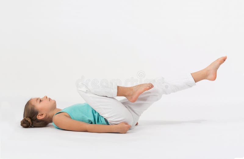 A girl makes gymnastic exercise lying