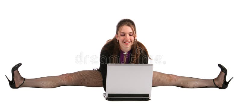 Girl makes splits and works with laptop.