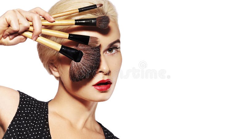 Girl with Makeup Beauty Brushes. Fashion Make-up for Sexy Woman. Make-up Artist Applying Visage on white background