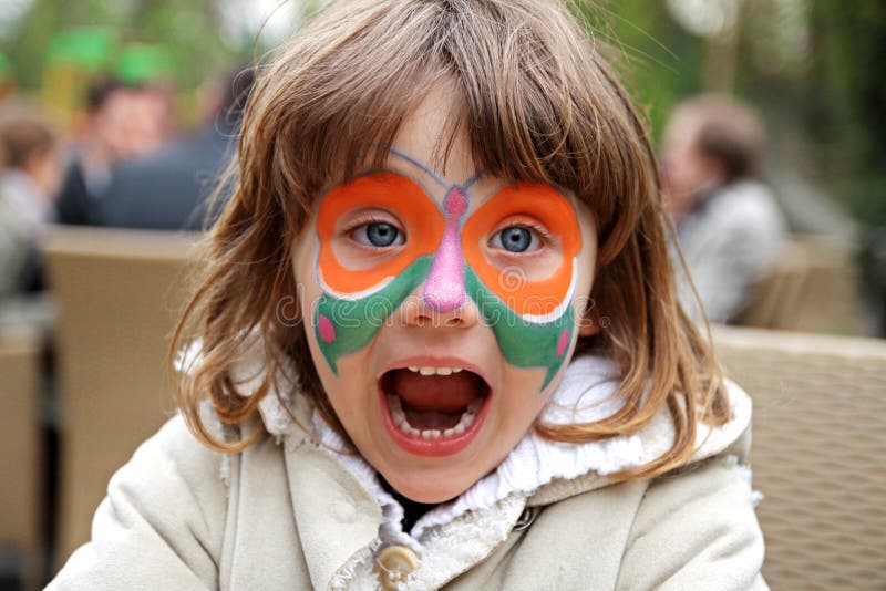 Girl making face painting - Butterfly