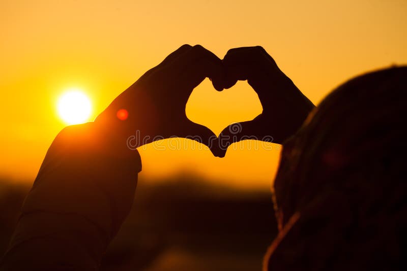 A girl making heart signs with her both hands stock photography A girl making heart signs with her both hands stock photography