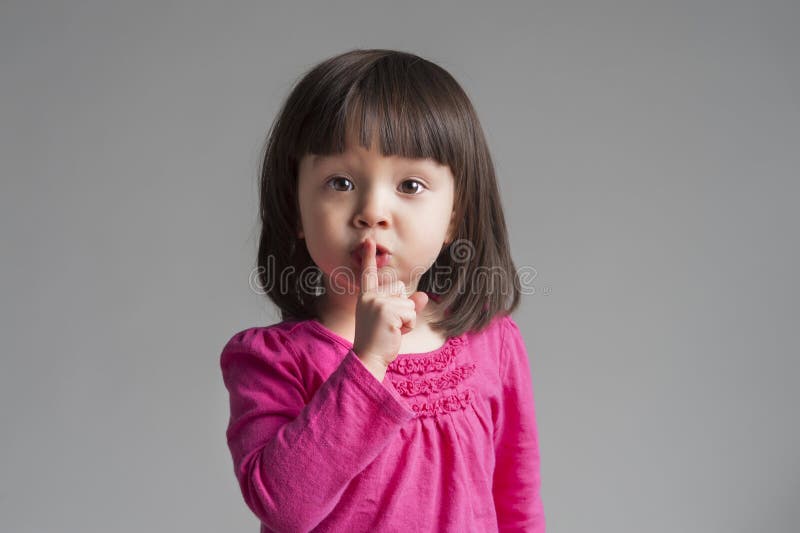 Girl Making A Keep Quiet Gesture stock image Girl Making A Keep Quiet Gesture stock image
