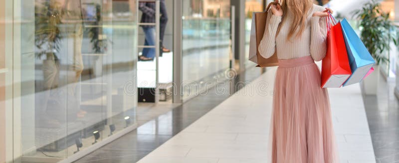 Girl in mall with shopping bags shopping on Black Friday.Shopper. Sales. Shopping Center. Cyber Monday.Copy space. Banner