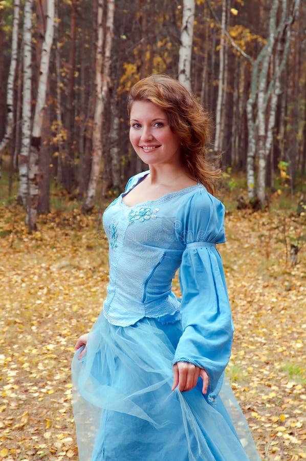 Girl in medieval dress in autumn wood