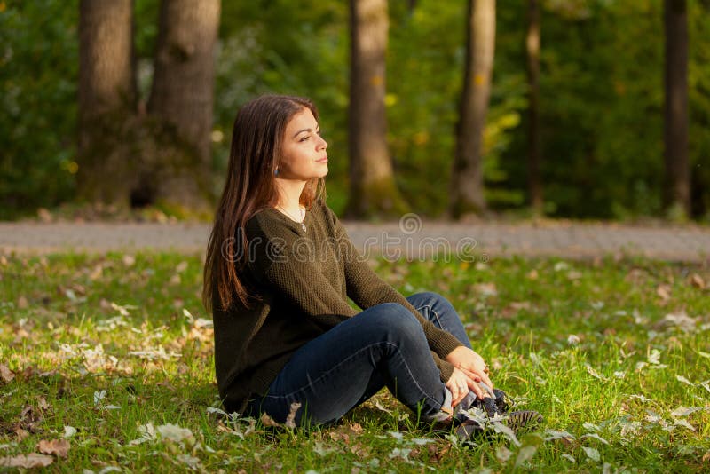 The girl meditates in park