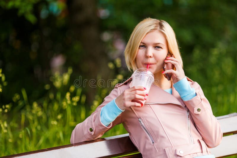 Girl with milkshake and phone