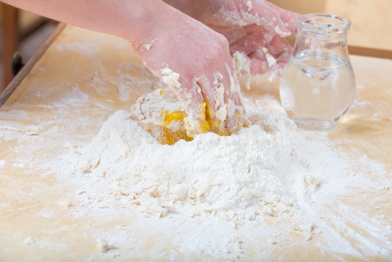 Girl is Mixing by Hand the Water, Flour and an Egg Stock Photo - Image ...
