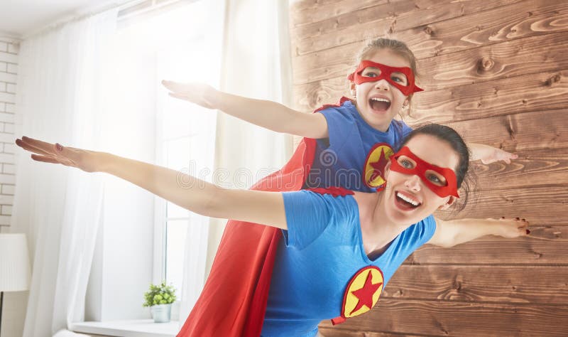Girl and mom in Superhero costumes stock images Girl and mom in Superhero costumes stock images