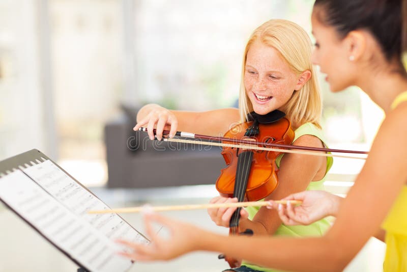 Girl music class. Beautiful preteen girl in music class with music teacher Girl music class. Beautiful preteen girl in music class with music teacher