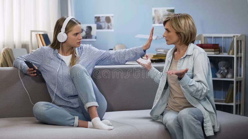 girl music headphones showing stop gesture to shouting mother generation gap girl music headphones showing stop gesture to 137522107