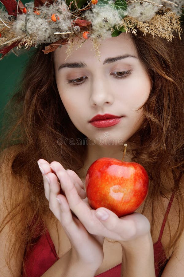 Girl in natural wreath with apple