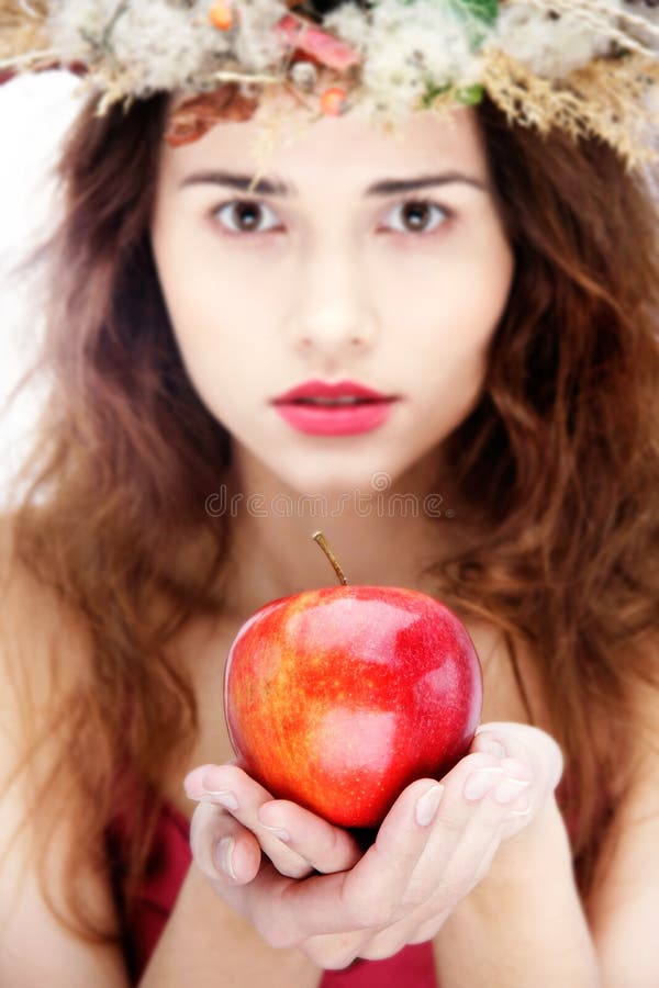 Girl in natural wreath with apple