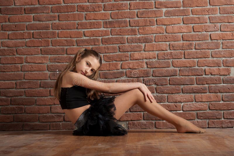 Girl near brick wall