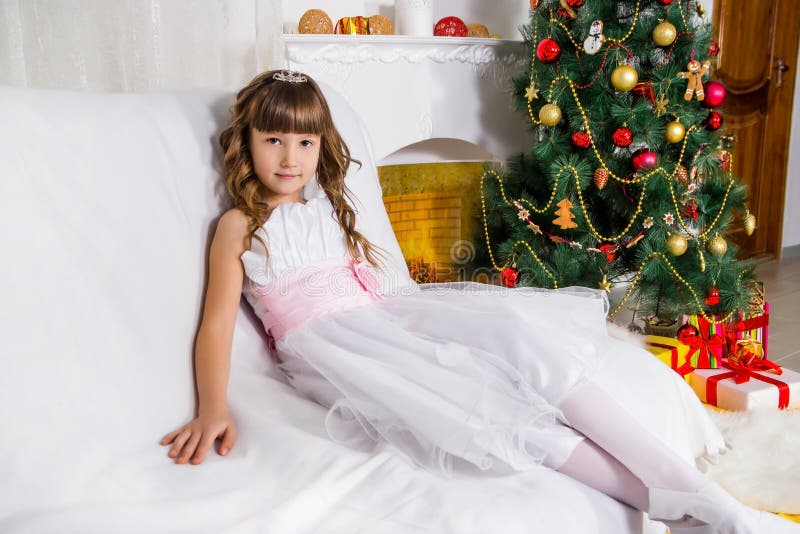 Girl near the decorated Christmas tree