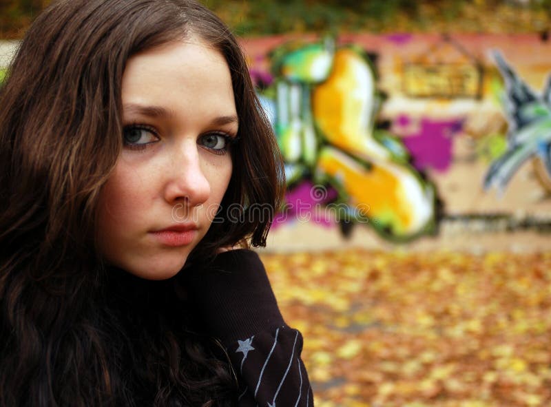 Girl near the graffiti wall