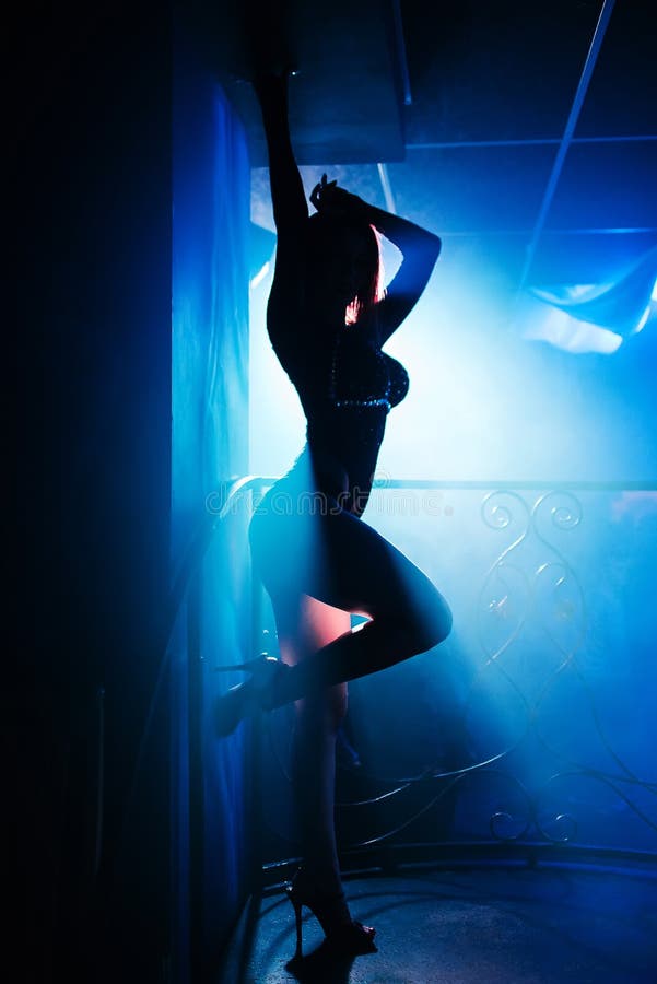 Girl with nice body posing at a nightclub at a party silhouette