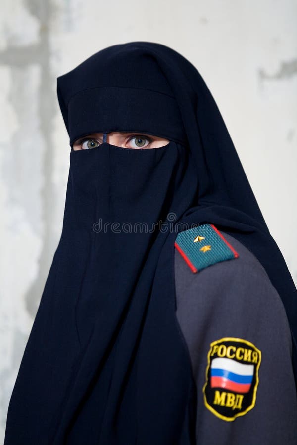 Girl in niqab and uniform of a Russian policeman