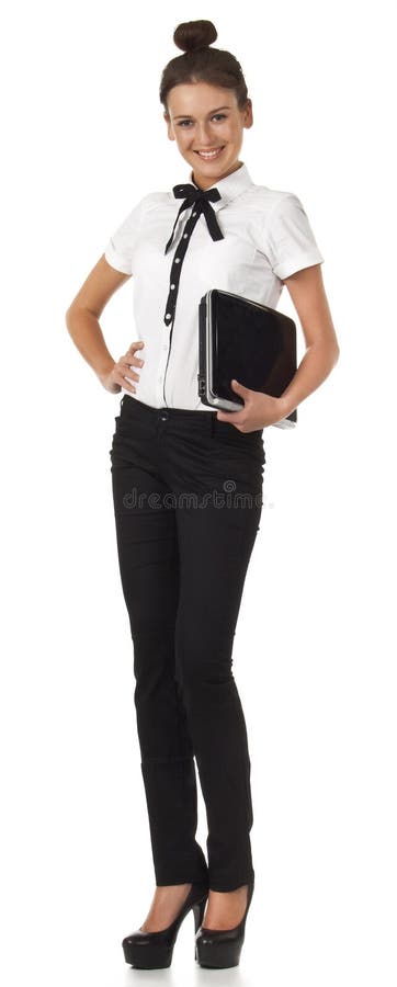 Girl in office attire stands and holds a laptop co