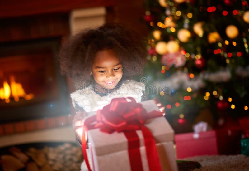 Girl opening Christmas magic presents