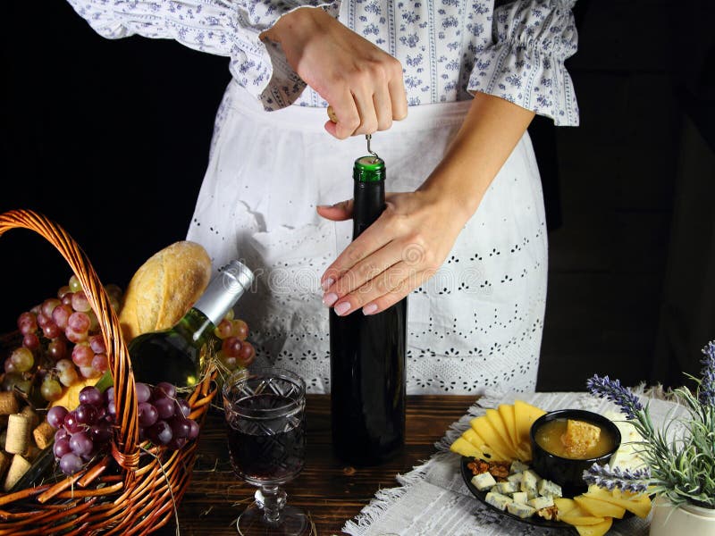 The girl opens a bottle stock image. Image of camembert 103033137