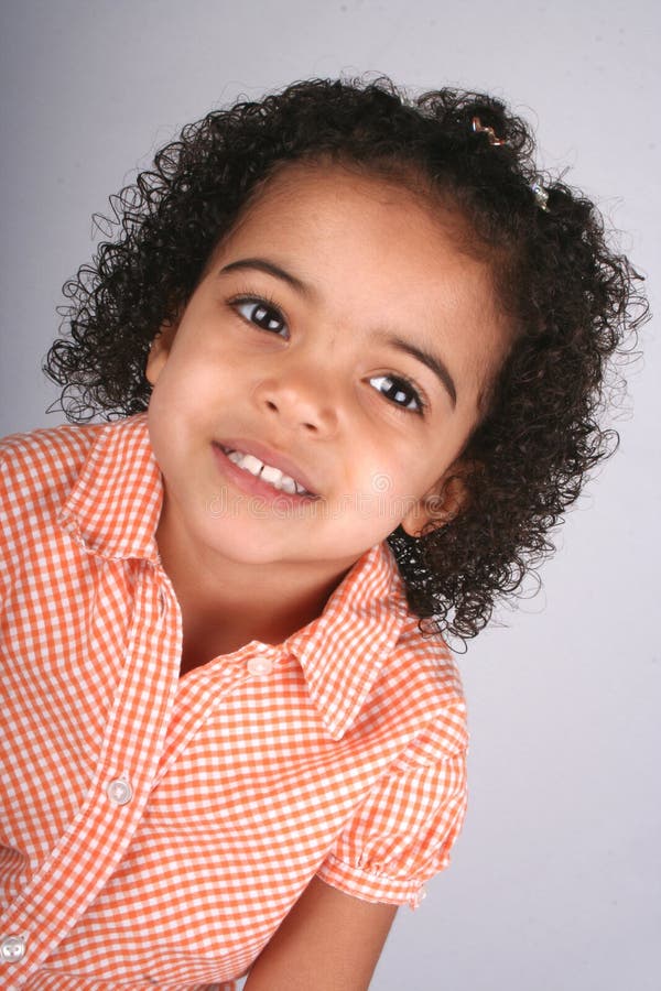 Girl in Orange Shirt stock photo. Image of curly, look 2436086