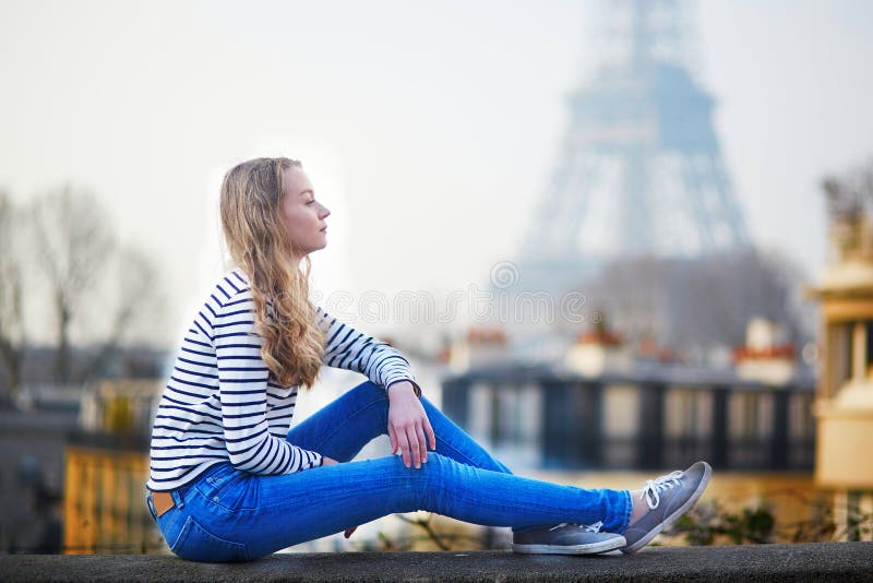 Girl outdoors near the Eiffel tower, in Paris.