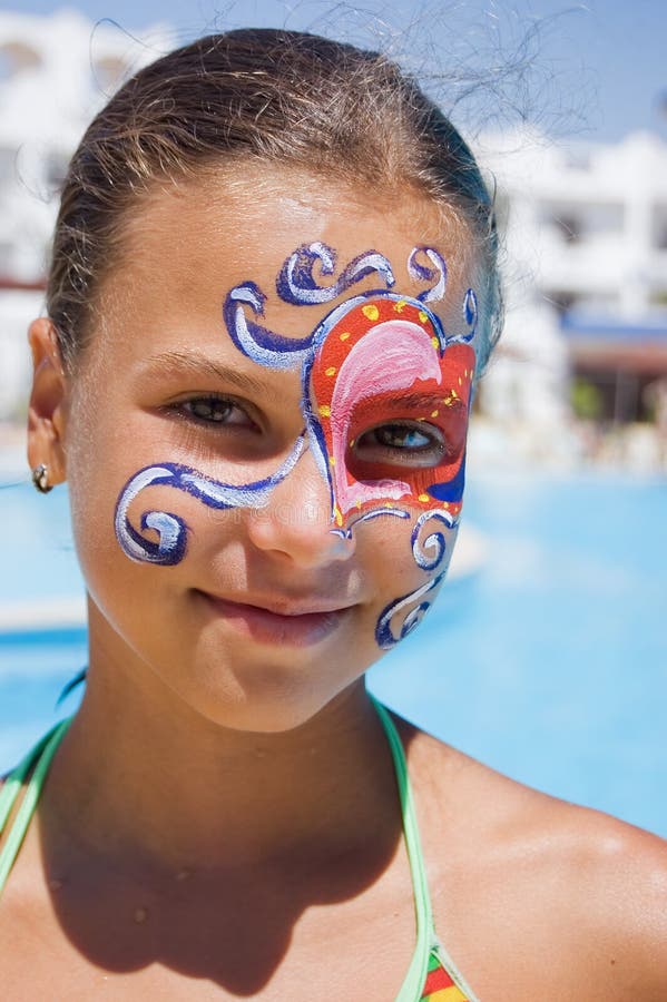 Girl with paint on his face in the pool