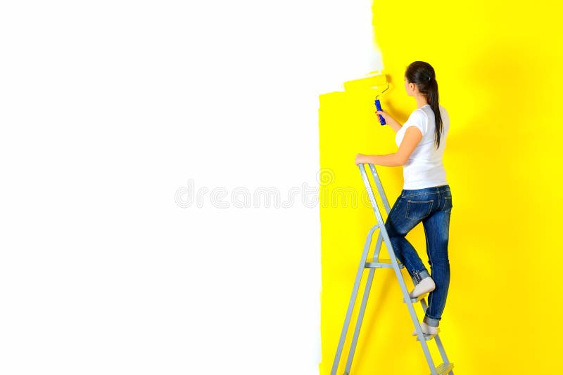 Girl painter paints a wall royalty free stock images Girl painter paints a wall royalty free stock images