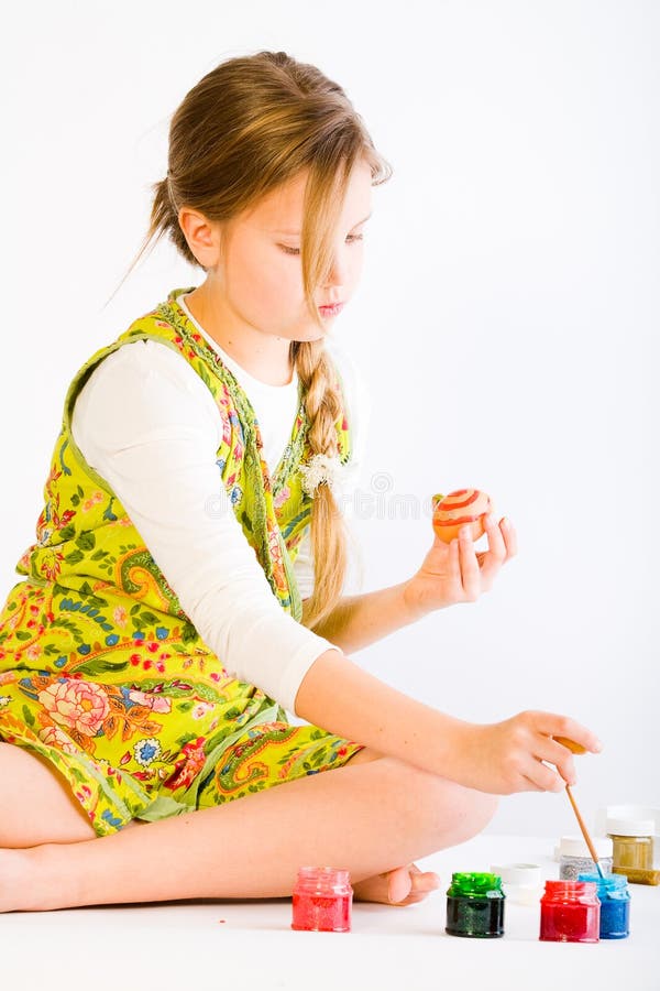 Girl painting easter eggs