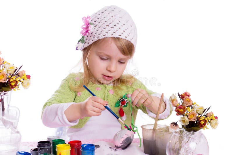 Girl painting eggs for Easter