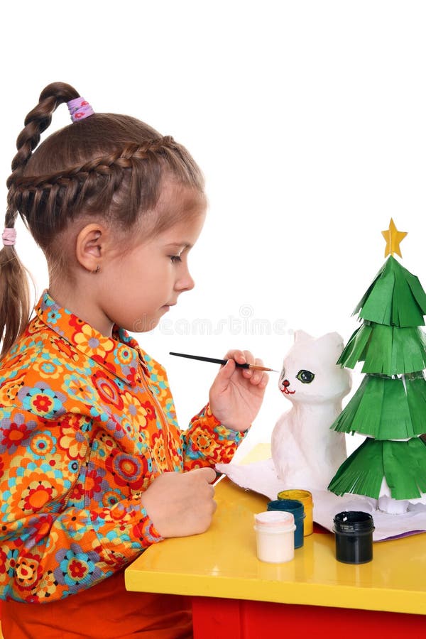 A girl paints the figure of a white cat royalty free stock images A girl paints the figure of a white cat royalty free stock images