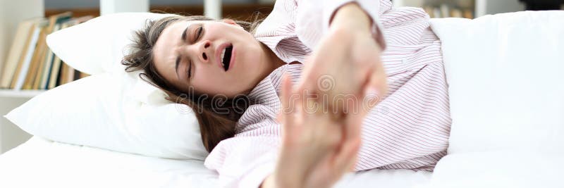 Girl in pajamas lies on bed and stretches, yawning royalty free stock images Girl in pajamas lies on bed and stretches, yawning royalty free stock images