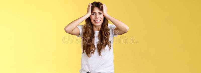 Girl panicking huge trouble suffer panic-attack grimacing painful feelings inside hold hands head troubled frustrated frowning anxiously staring camera troublesome problematic situation.