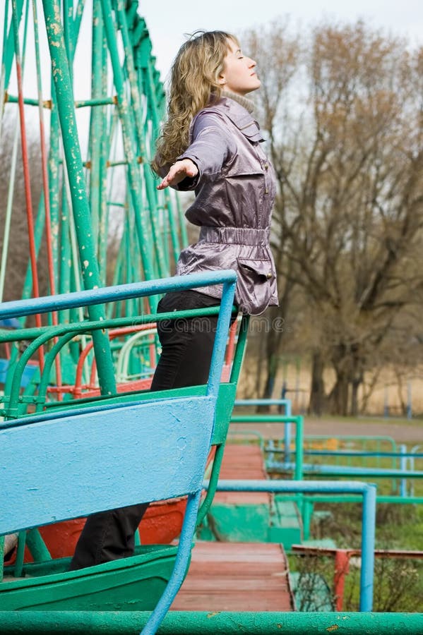 Girl in park on old swing