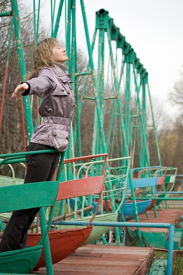 Girl in park on old swing