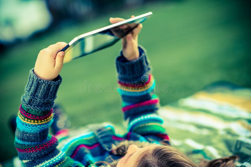 Girl in Park with Tablet