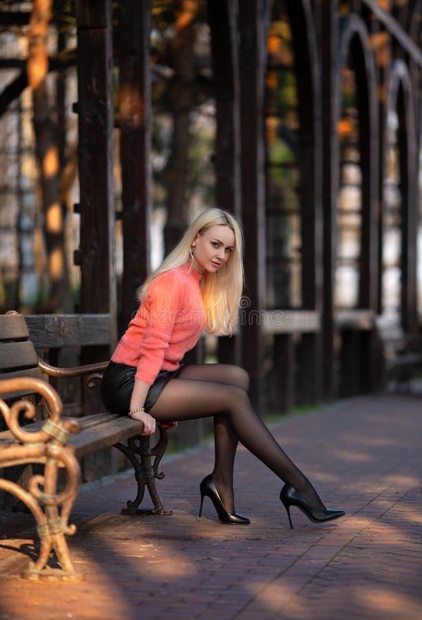 Girl in pantyhose andi shorts posing in pubblic park Stock Photo