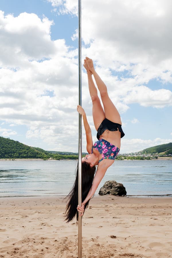 Girl performs acrobatic dance on pole for dancing stock photos Girl performs acrobatic dance on pole for dancing stock photos