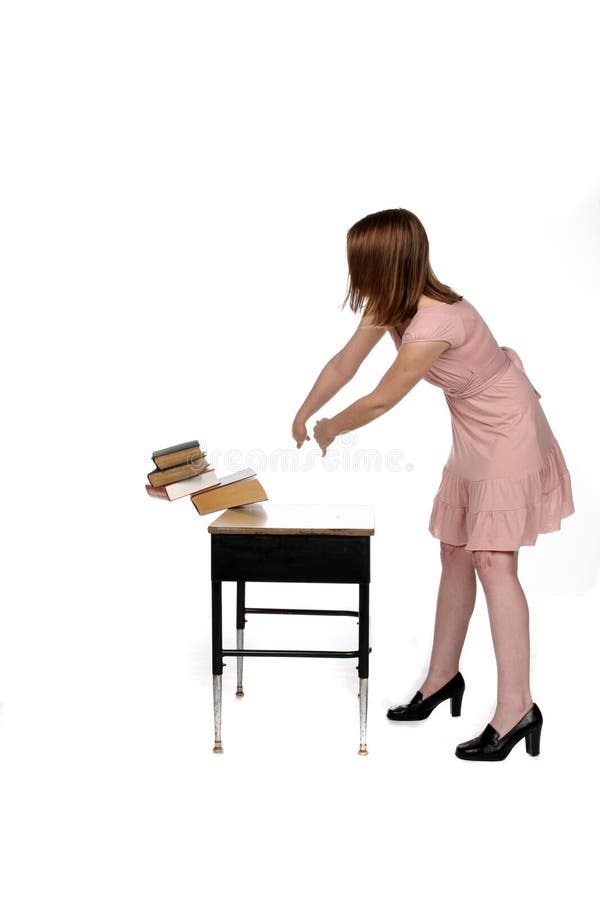 Girl in pink dress dumping books of the desk