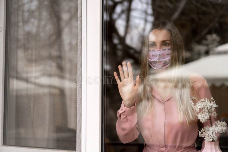 Girl in a Pink Dress and a Pink Medical Mask. Self-isolation at Home ...