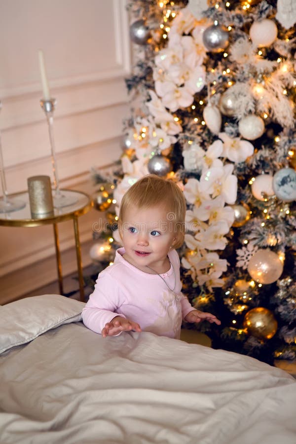 Girl in Pink Pajamas Having Fun on a Large Bed on Christmas Day Stock ...