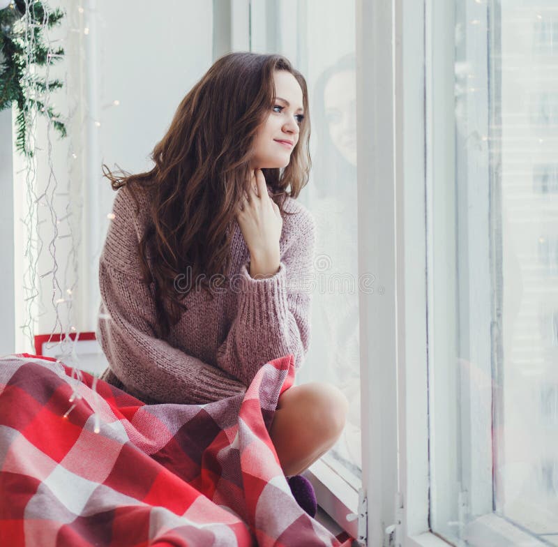 Girl in plaid sitting at the window royalty free stock photos Girl in plaid sitting at the window royalty free stock photos
