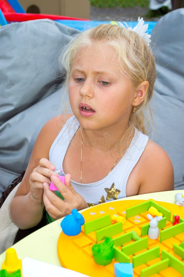 Girl playing a board game stock photo. Image of chair 43681602