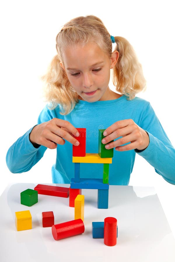 Girl is playing with colorful wooden blocks royalty free stock photos