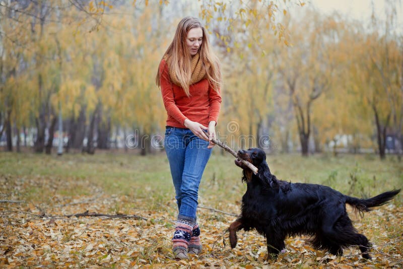 Girl playing with dog in park